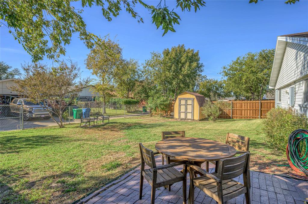 2038 Rose Hill Road Carrollton, TX 75007 - Photo 32 of 35 a view of a wooden chairs and table in backyard of the house