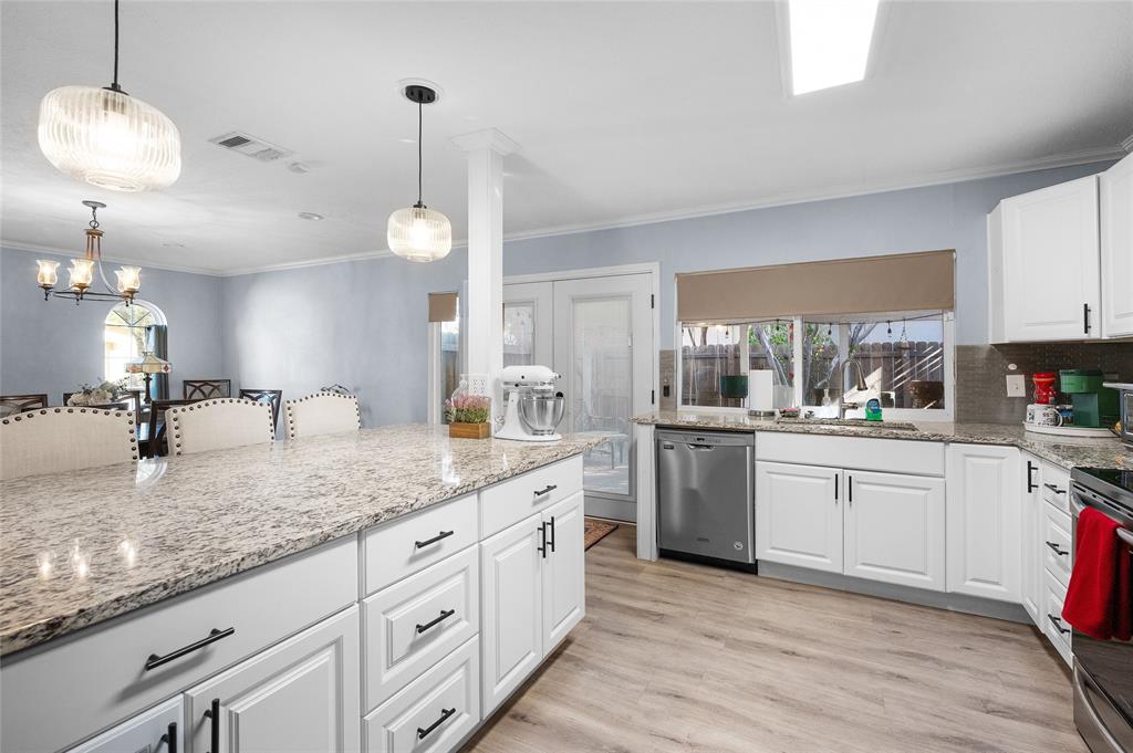 2038 Rose Hill Road Carrollton, TX 75007 - Photo 8 of 35 a kitchen with white cabinets and white appliances