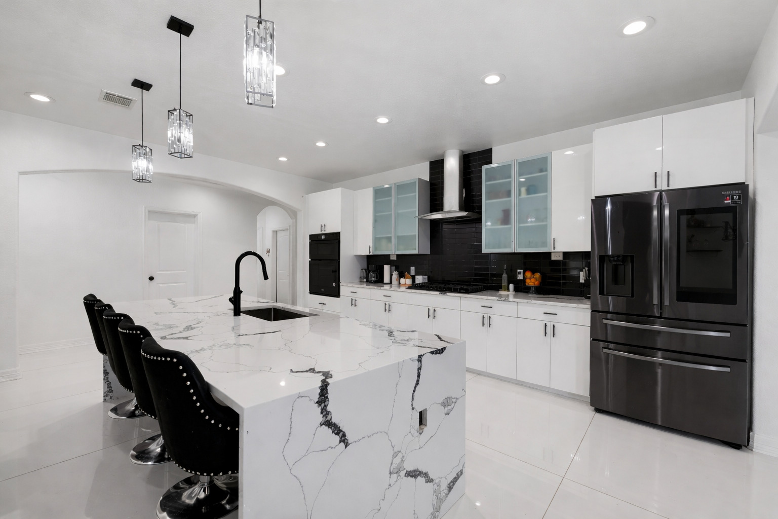 507 Rawhide Road Seguin, TX 78155 - Photo 14 of 40 Kitchen featuring black appliances, white cabinets, arched walkways, and a kitchen breakfast bar