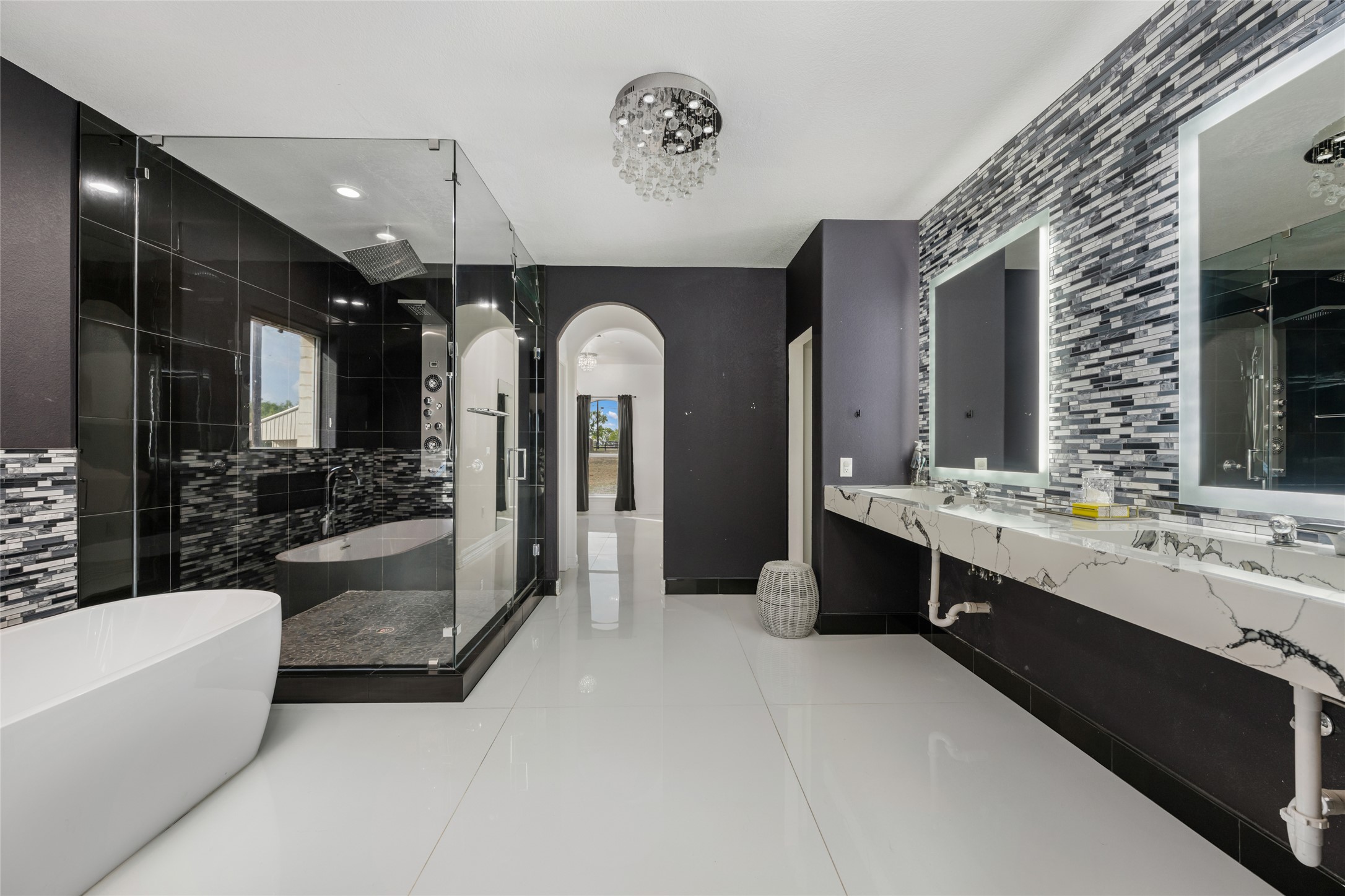 507 Rawhide Road Seguin, TX 78155 - Photo 18 of 40 Bathroom featuring a freestanding bath, double vanity, a stall shower, light tile patterned floors, and tasteful backsplash
