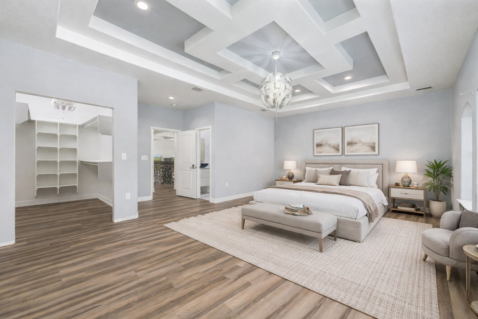 507 Rawhide Road Seguin, TX 78155 - Photo 26 of 40 Bedroom featuring a walk in closet, coffered ceiling, suspended lighting, and wood finished floors