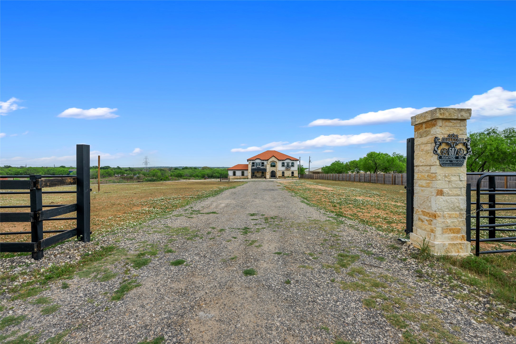 507 Rawhide Road Seguin, TX 78155 - Photo 3 of 40 View of dirt / gravel driveway with a gate and a gated entry