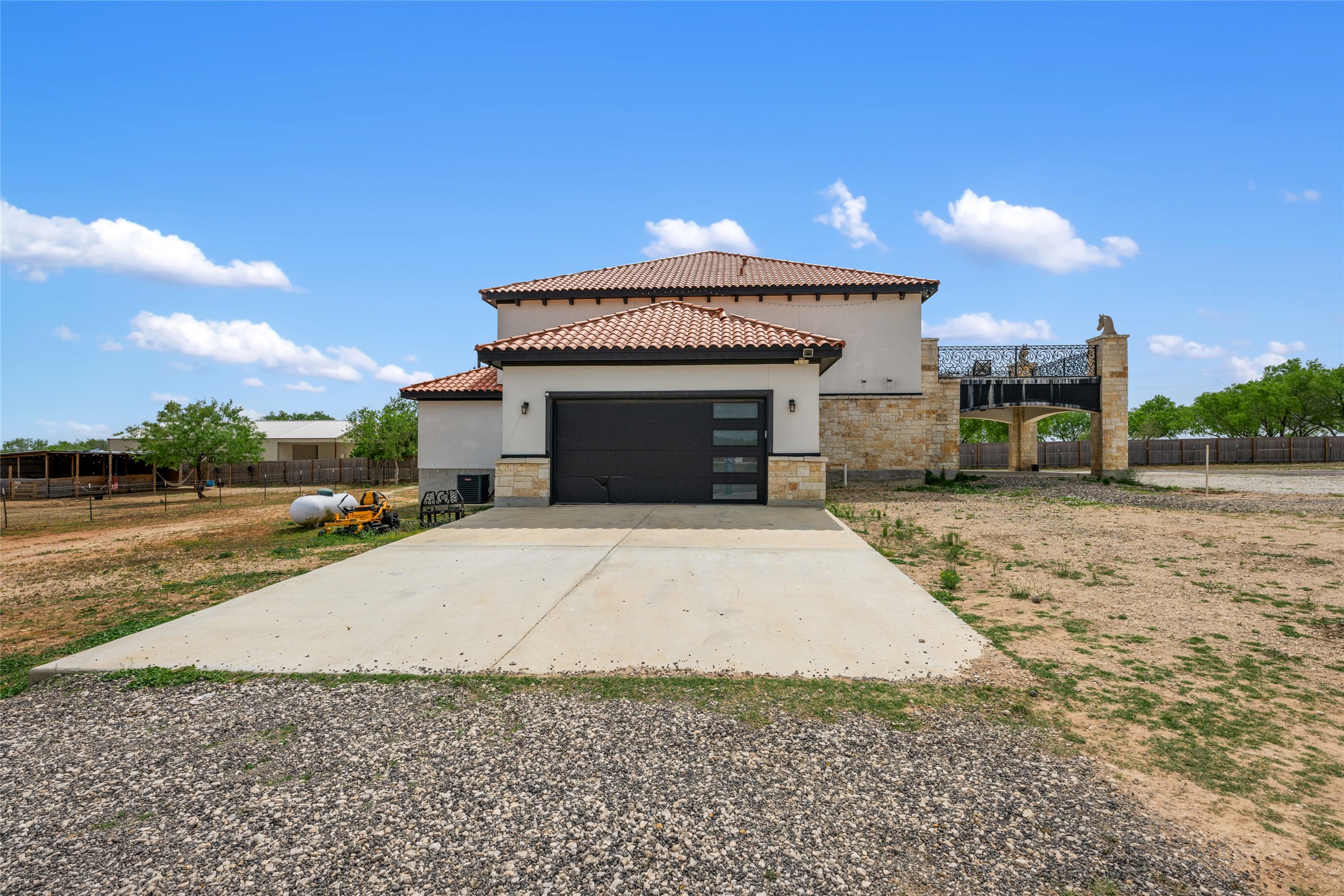 507 Rawhide Road Seguin, TX 78155 - Photo 4 of 40 View of front of house featuring stone siding, concrete driveway, an attached garage, and stucco siding