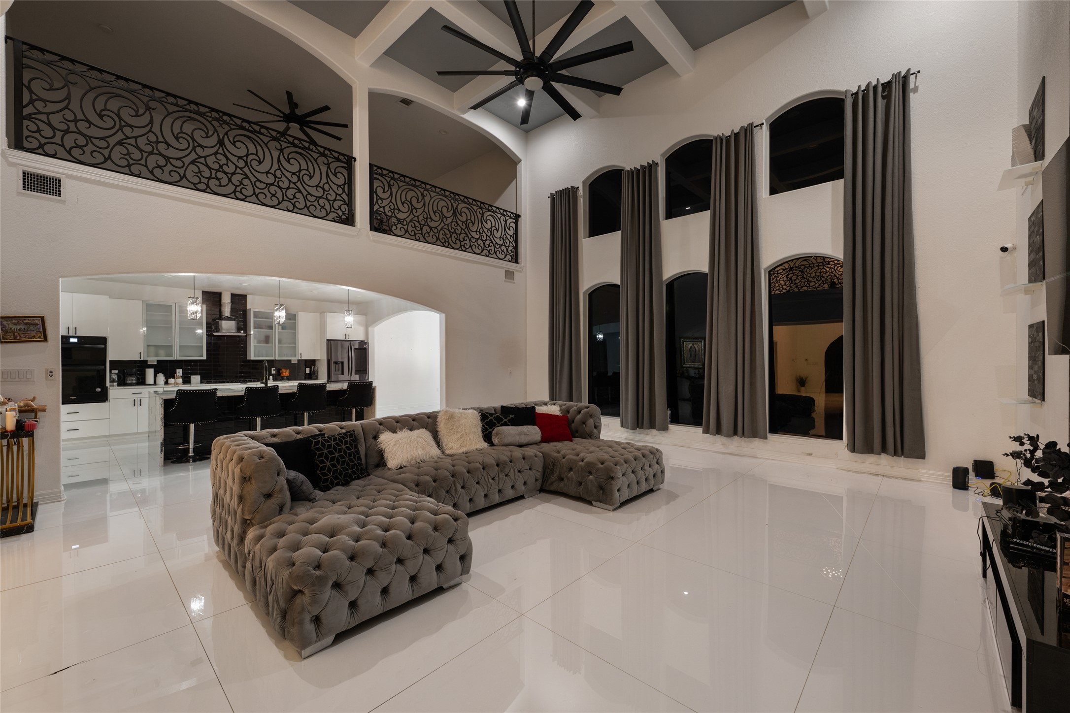 507 Rawhide Road Seguin, TX 78155 - Photo 10 of 40 Living room with arched walkways, light tile patterned floors, a ceiling fan, recessed lighting, and high coffered ceiling
