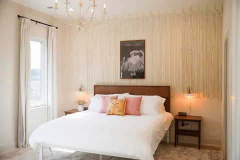 a bedroom with a bed and a table