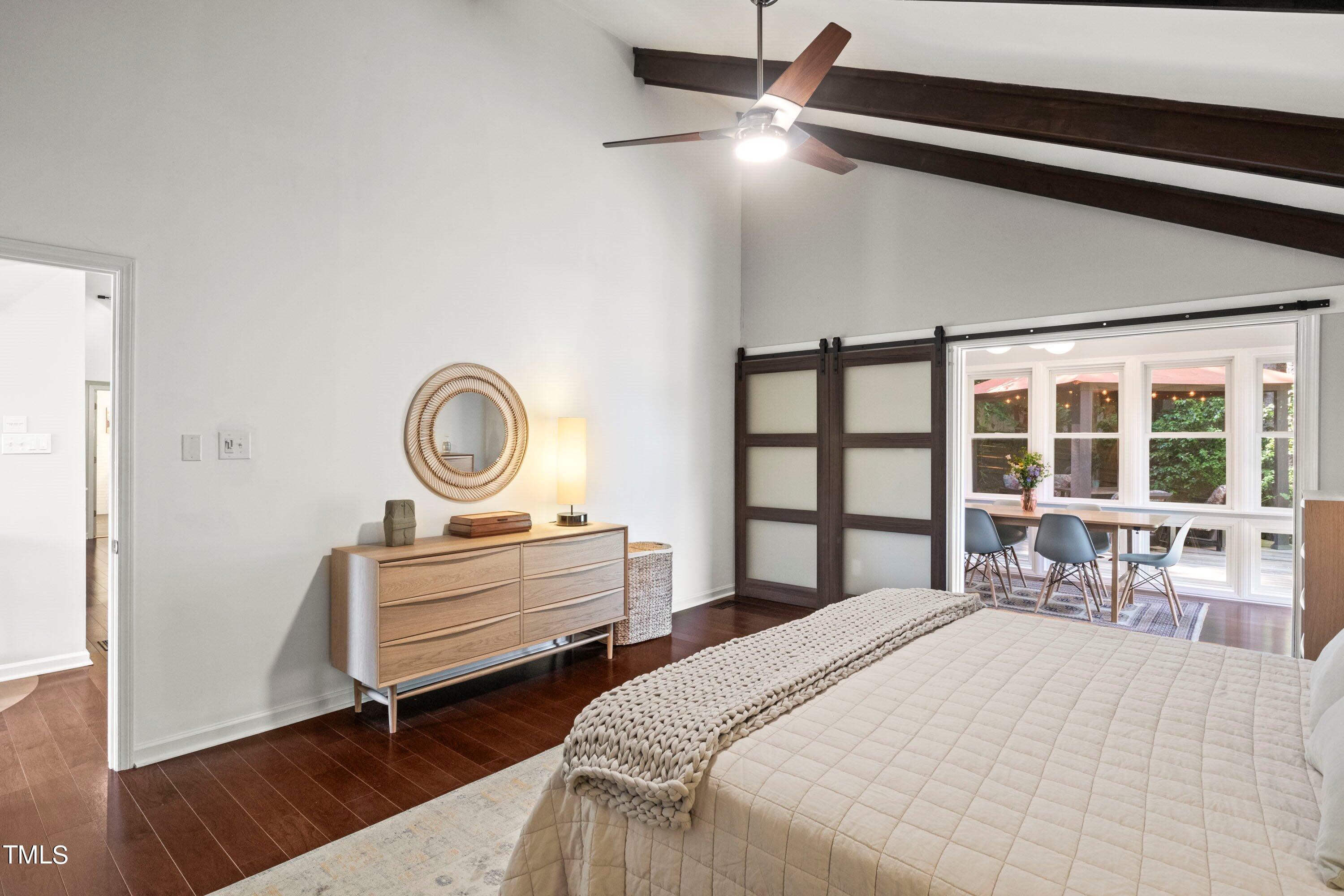 2762 Rue Sans Famille Raleigh, NC 27607 - Photo 21 of 35 a bedroom with a bed and a large window with chair