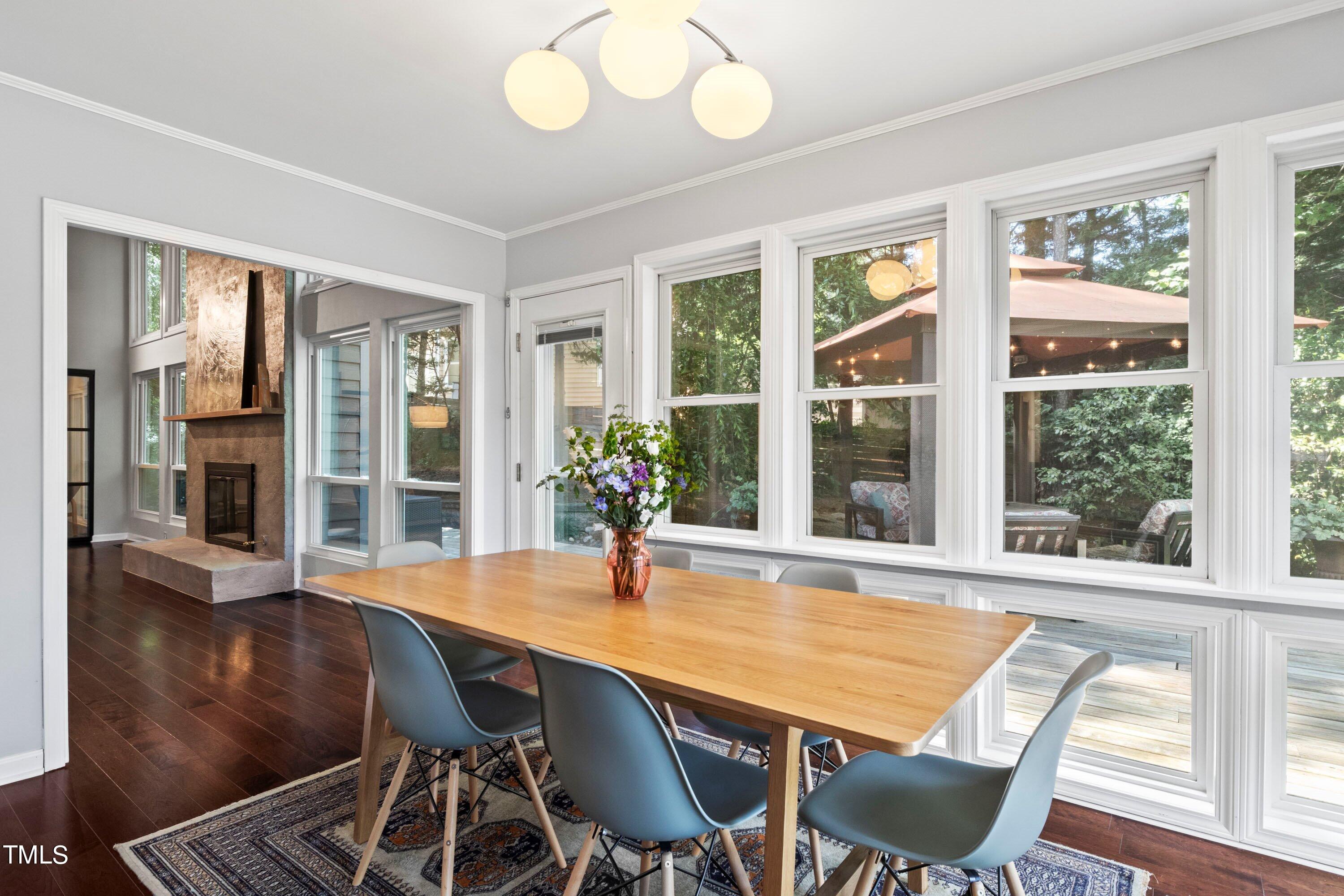 2762 Rue Sans Famille Raleigh, NC 27607 - Photo 9 of 35 a dining room with wooden floor and large windows