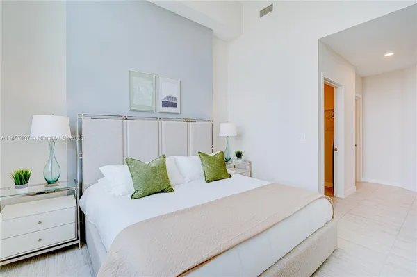 a bed room with a bed and a lamp