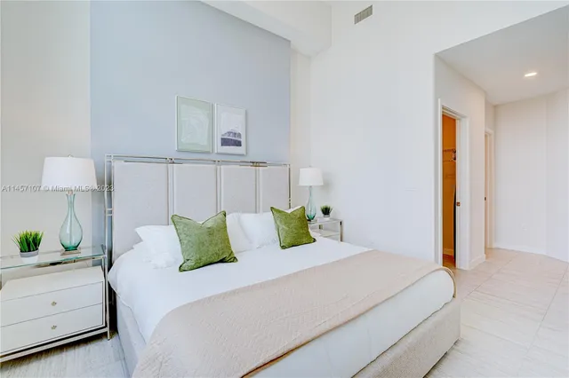 a bed room with a bed and a lamp