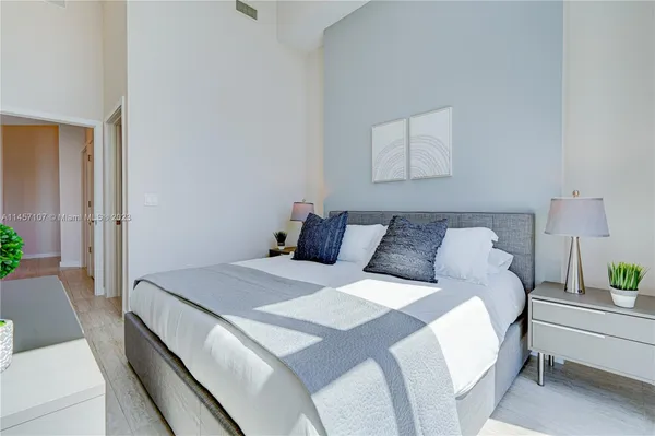 a bedroom with a bed and a mirror
