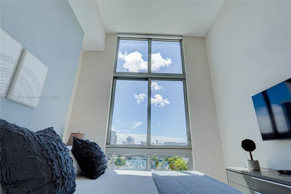 a view of a hallway with view of living room and bathroom