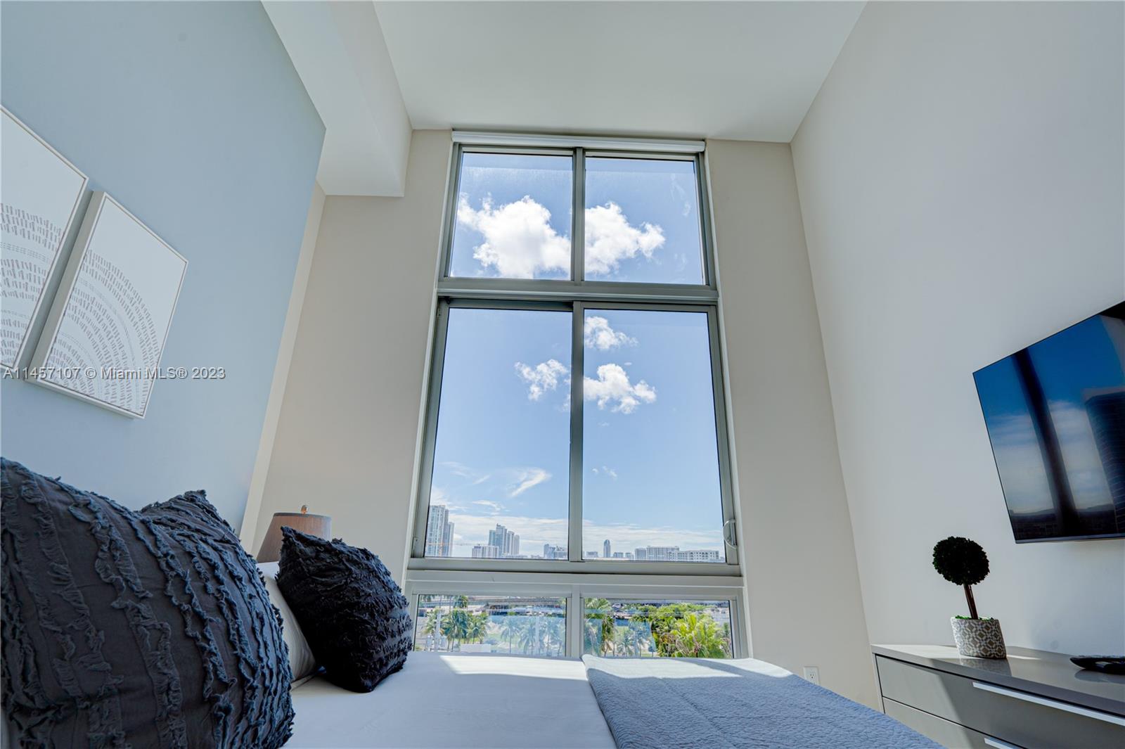 3900 Biscayne Boulevard, Unit S502 Miami, FL 33137 - Photo 16 of 35 a bedroom with a bed and a mirror