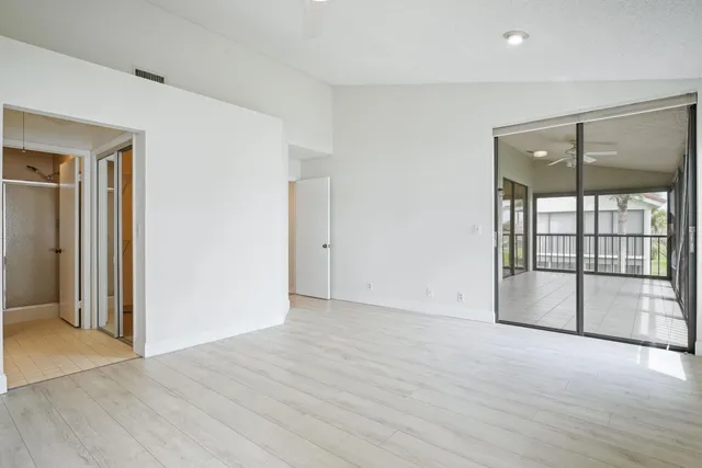 a kitchen with white cabinets and refrigerator