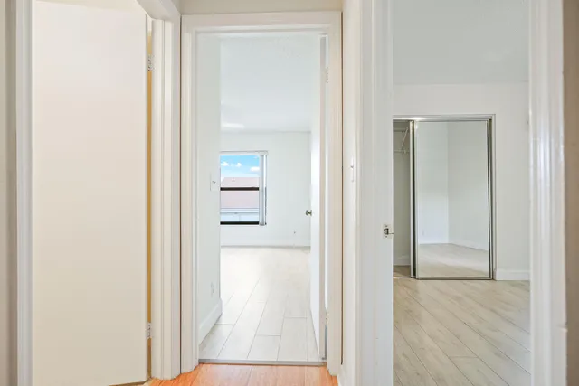 a view of an empty room with wooden floor
