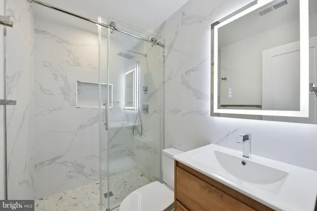 a bathroom with a sink toilet and shower