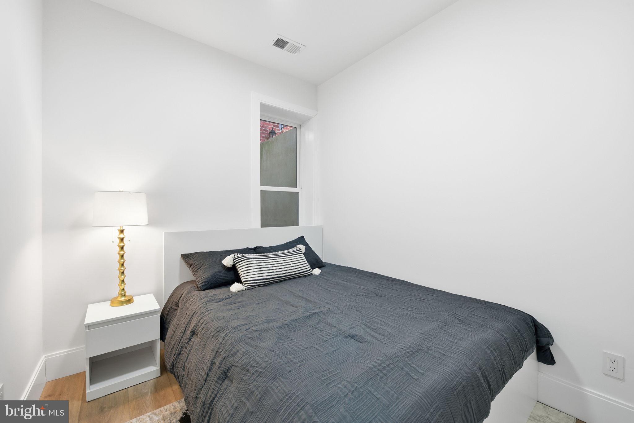 1714 Euclid Street Northwest, Unit 2 Washington, DC 20009 - Photo 13 of 20 a bedroom with a bed and a night stand