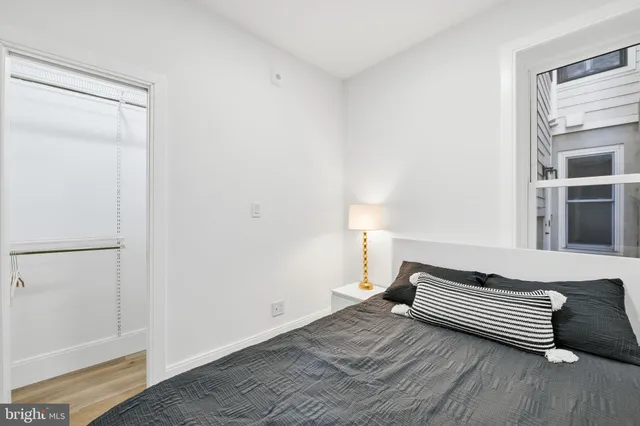 a bedroom with a bed and a window