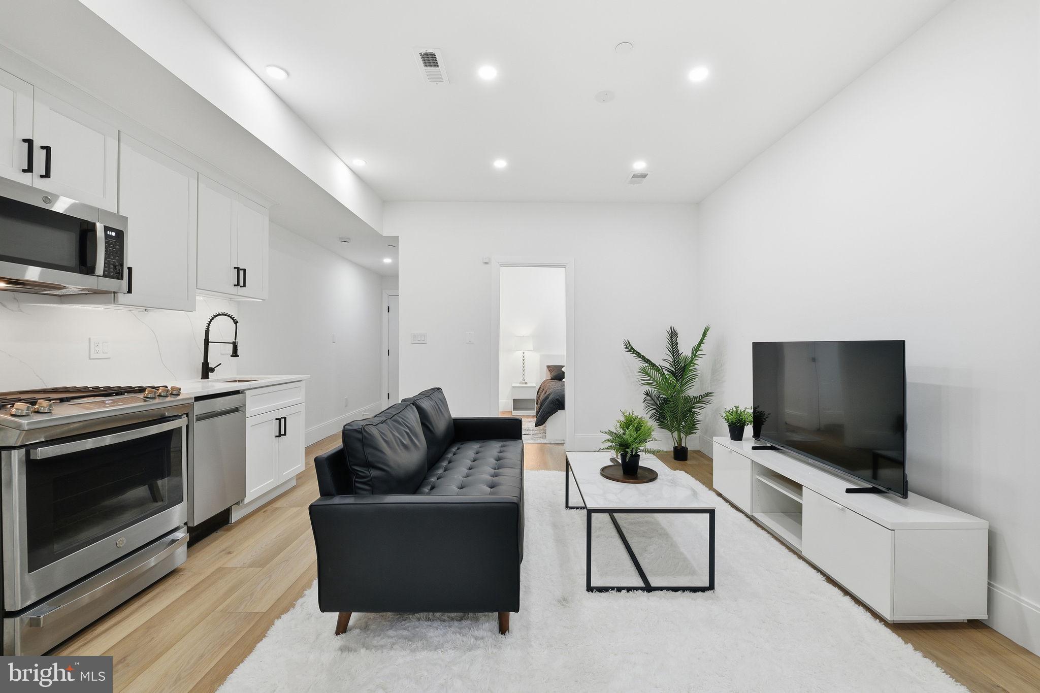 1714 Euclid Street Northwest, Unit 2 Washington, DC 20009 - Photo 5 of 20 a living room with furniture and a flat screen tv
