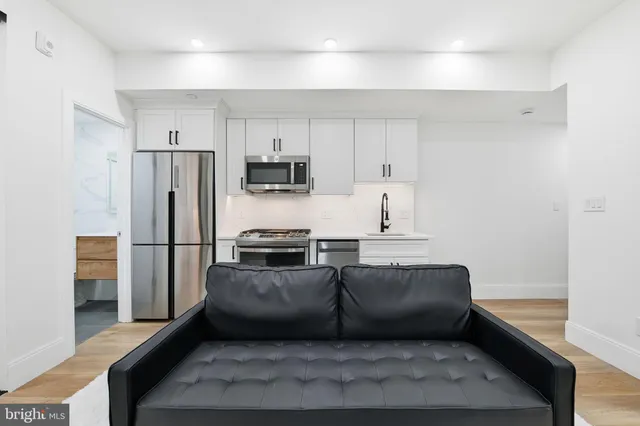 a kitchen with stainless steel appliances a refrigerator and a stove
