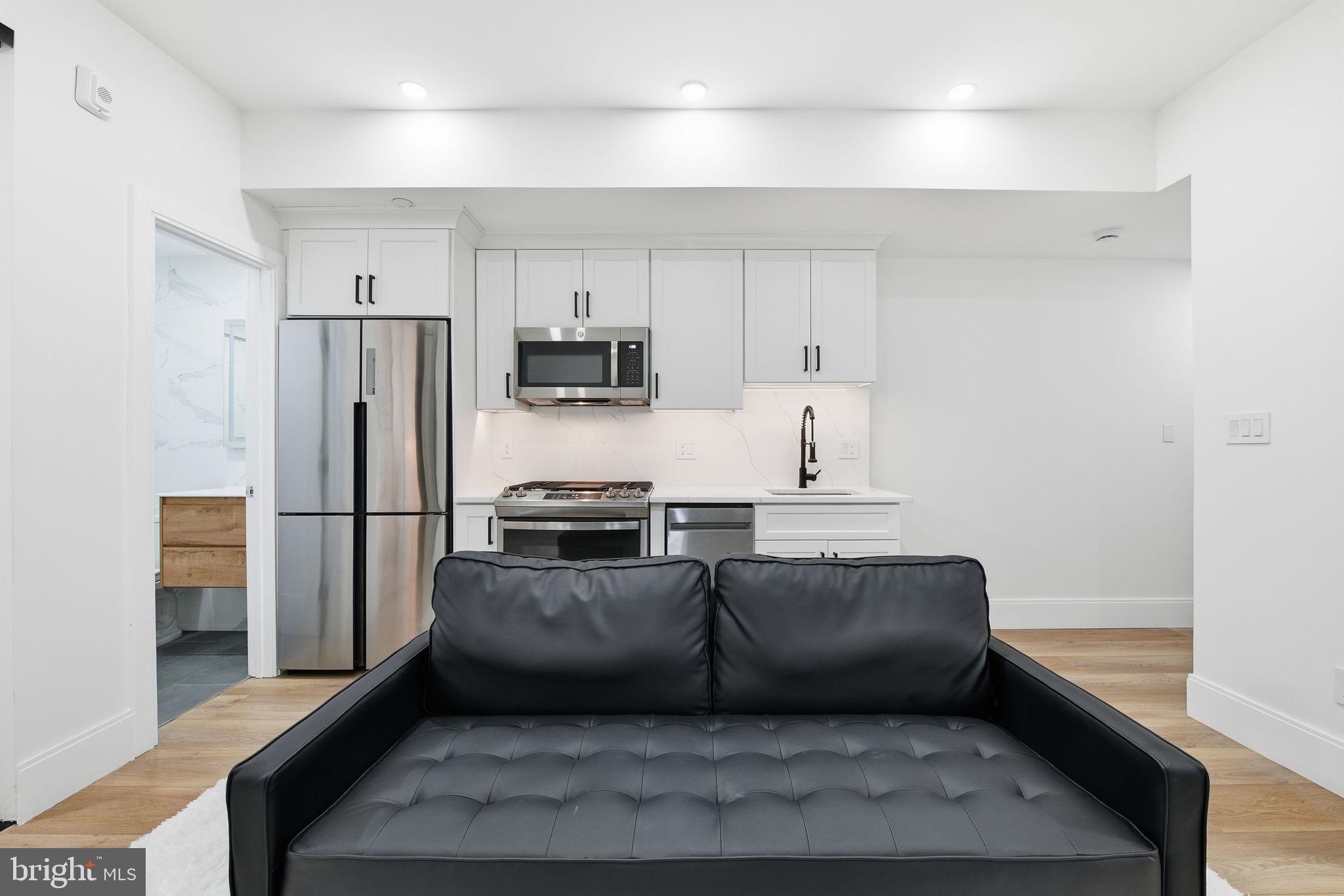 1714 Euclid Street Northwest, Unit 2 Washington, DC 20009 - Photo 7 of 20 a kitchen with stainless steel appliances a refrigerator and a stove