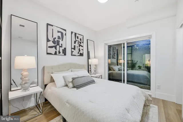 a bedroom with a bed and a lamp on table