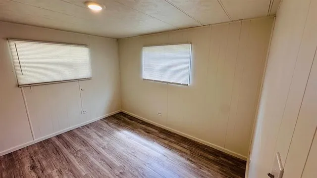 a view of room with wooden floor