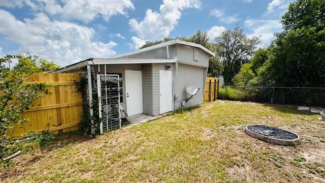 a view of a house with wooden fence