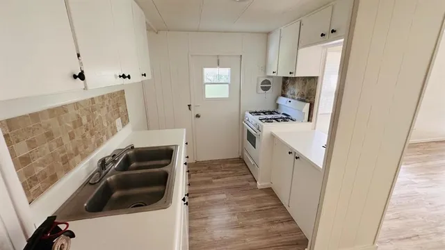 a kitchen with a sink and a stove top oven