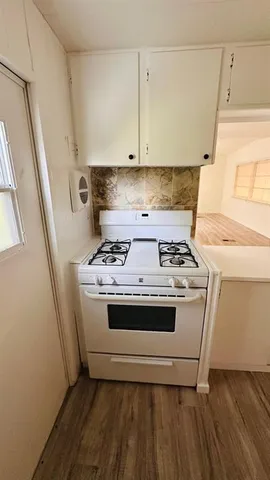 a white stove top oven sitting inside of a kitchen