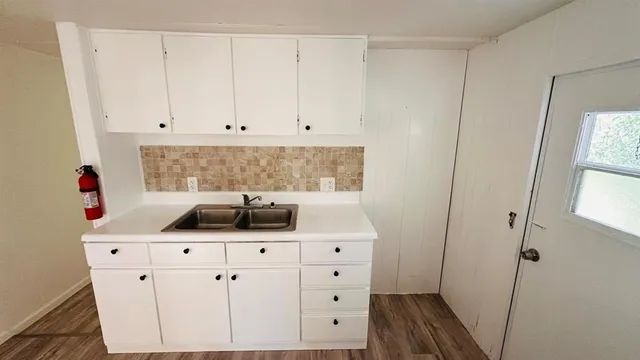 a kitchen with a sink and cabinets