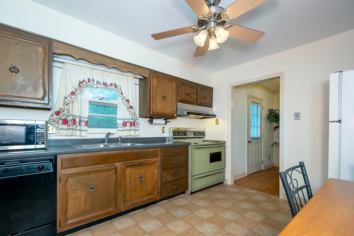 4635 Boyce Road Memphis, TN 38117 - Photo 10 of 19 a kitchen with stainless steel appliances granite countertop a sink and cabinets