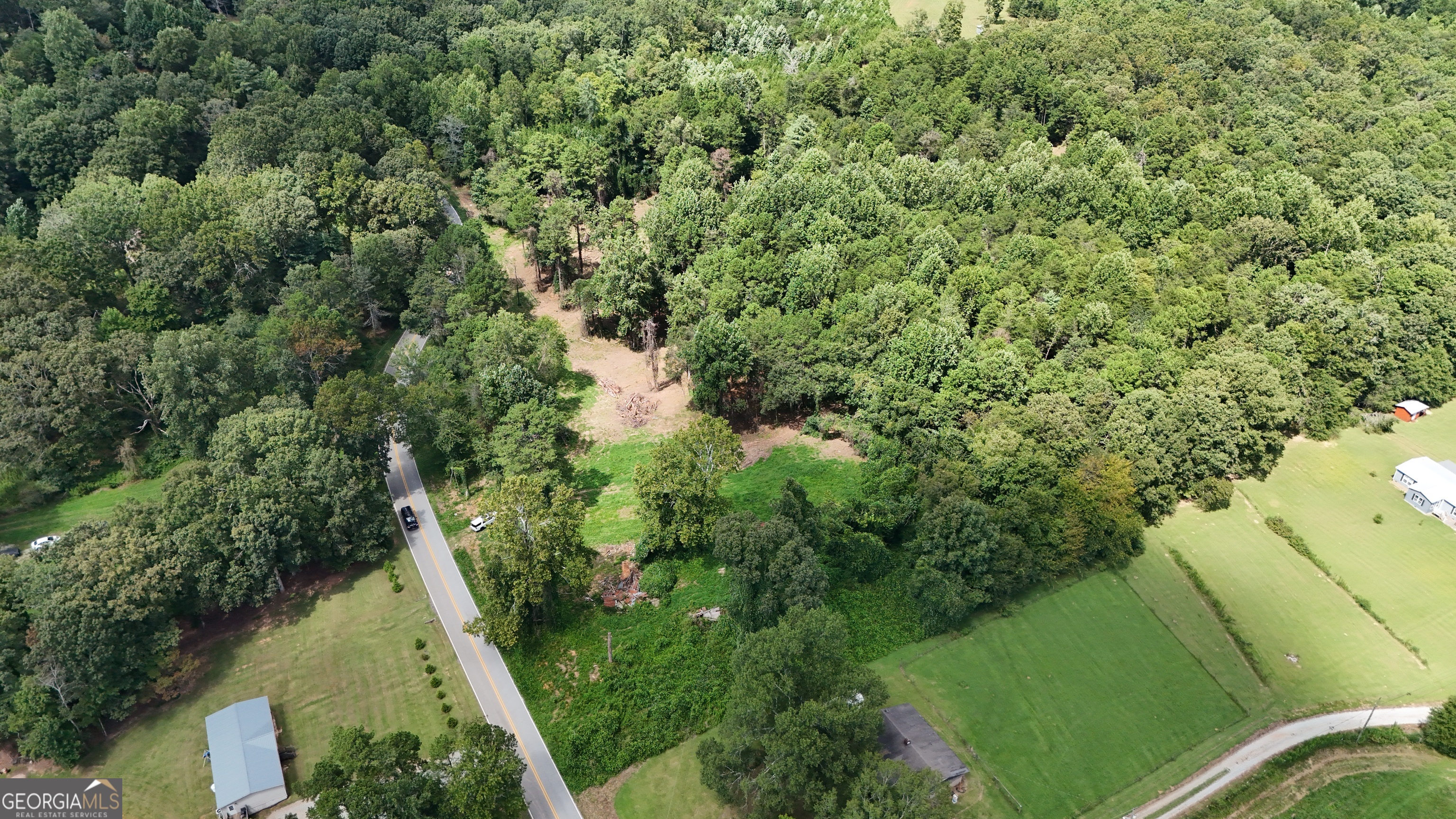 an aerial view of a house with a yard