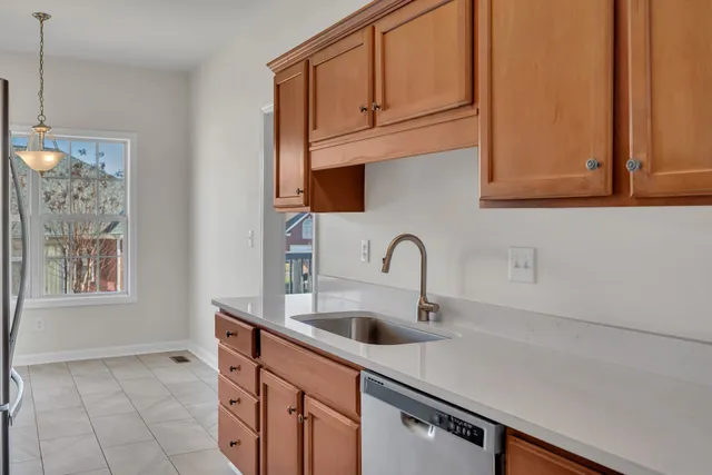 a kitchen with stainless steel appliances a sink a stove and cabinets
