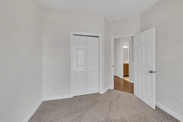 an empty room with windows and closet