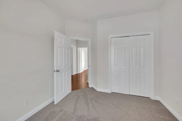 a bathroom with a granite countertop sink a toilet and bathtub