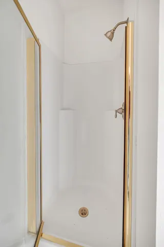 an empty room with a ceiling fan and window