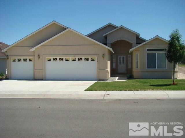 336 Bens Way Fernley, NV 89408 - Photo 1 of 1 a front view of a house with a yard and garage