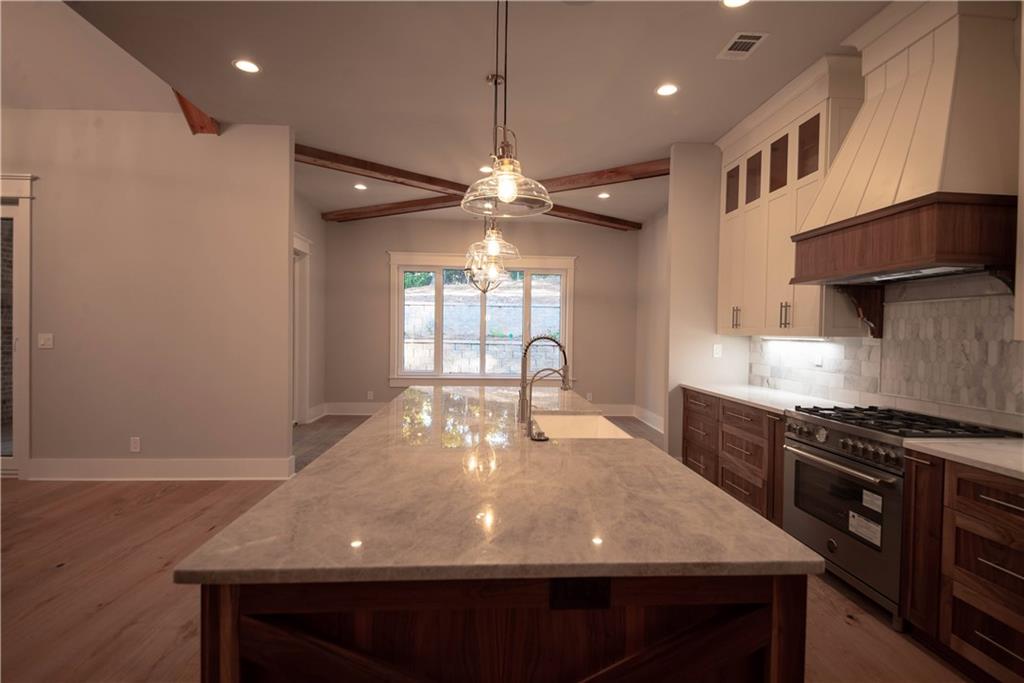 1303 North Druid Hills Road Northeast Atlanta, GA 30319 - Photo 13 of 39 a large kitchen with stainless steel appliances a large island in the center