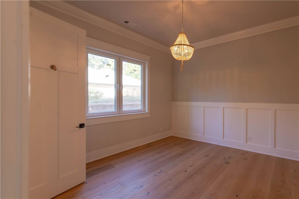 1303 North Druid Hills Road Northeast Atlanta, GA 30319 - Photo 21 of 39 an empty room with wooden floor and windows