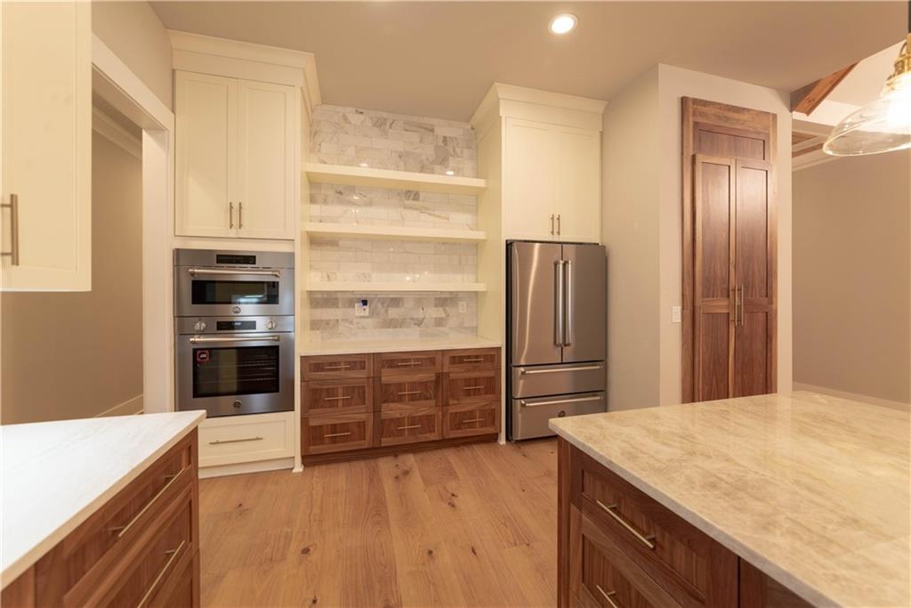 1303 North Druid Hills Road Northeast Atlanta, GA 30319 - Photo 28 of 39 a kitchen with a refrigerator and a stove top oven