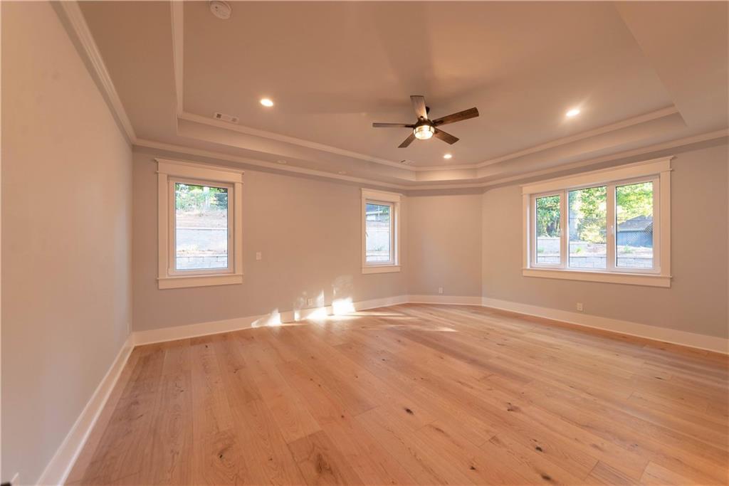 1303 North Druid Hills Road Northeast Atlanta, GA 30319 - Photo 29 of 39 a view of empty room with wooden floor and fan