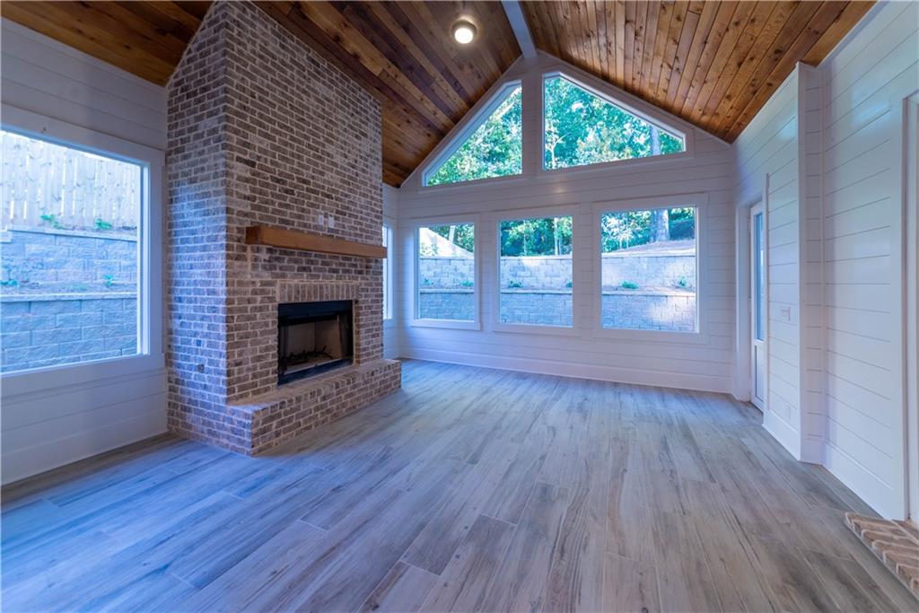1303 North Druid Hills Road Northeast Atlanta, GA 30319 - Photo 5 of 39 a view of empty room with wooden floor and fireplace