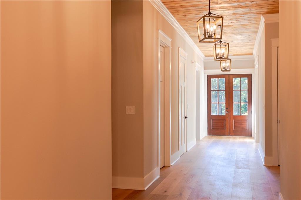 1303 North Druid Hills Road Northeast Atlanta, GA 30319 - Photo 6 of 39 a view of a hallway with wooden floor and staircase