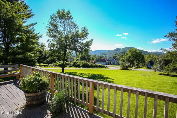 a view of balcony with wooden floor and fence