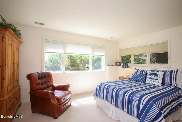 a bedroom with furniture and a large window