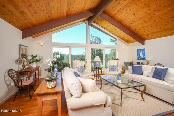 a living room with patio furniture and a large window