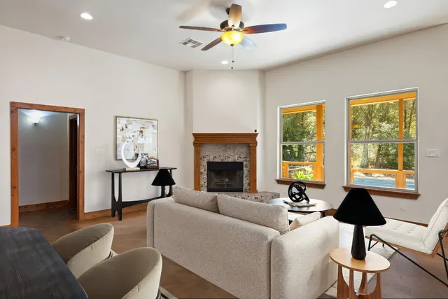a view of an empty room with window and fire place