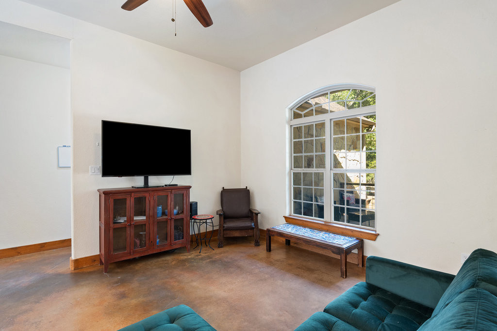 267 Corral Road Smithville, TX 78957 - Photo 16 of 40 a living room with furniture and a flat screen tv