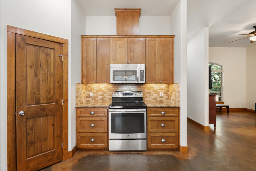 267 Corral Road Smithville, TX 78957 - Photo 19 of 40 a kitchen with a stove and a cabinet