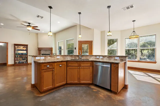 a kitchen with stainless steel appliances granite countertop a refrigerator stove and oven